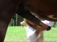 Very hot blonde giving blowjob to her horse